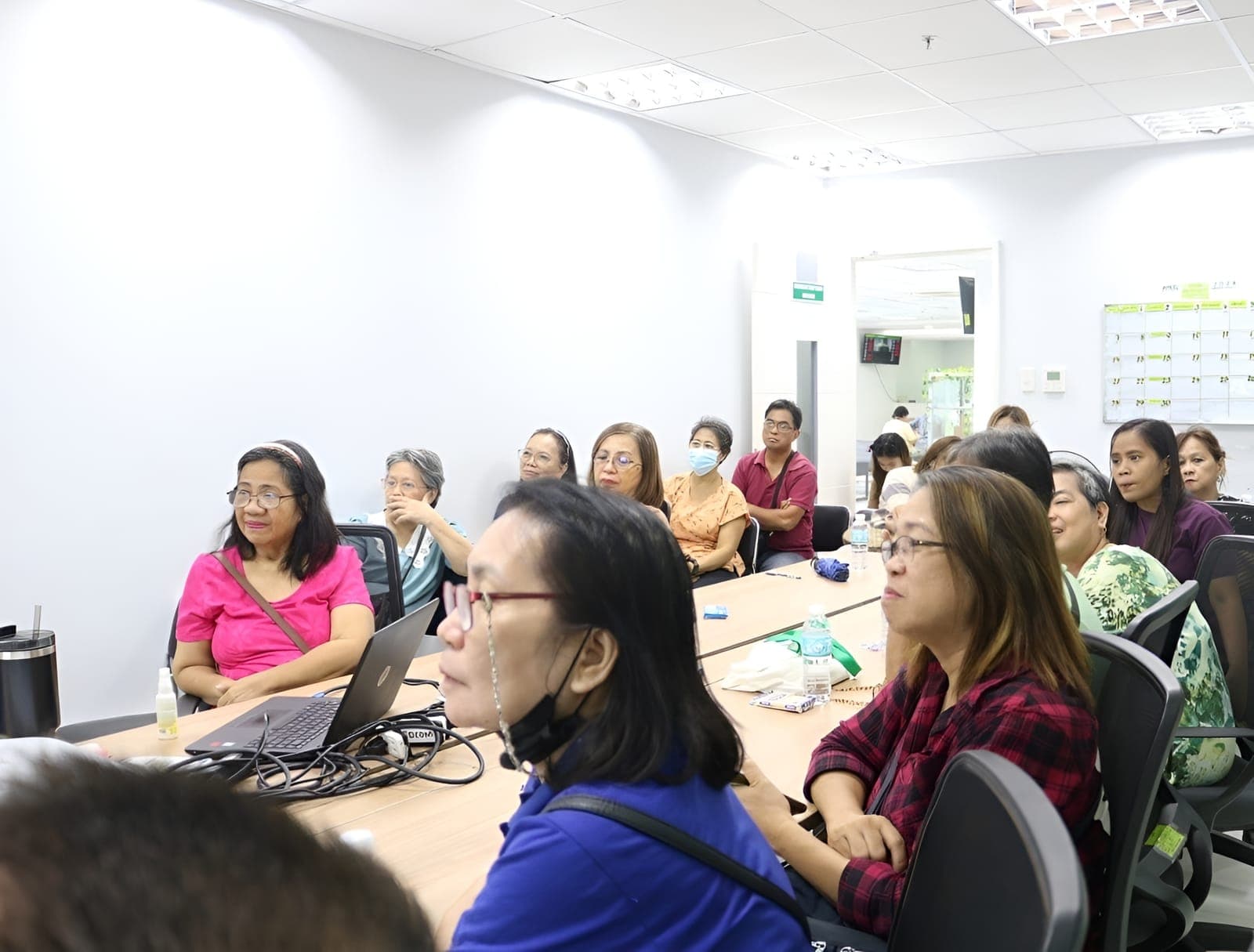 NOVADECI members attending a financial literacy seminar in a conference room