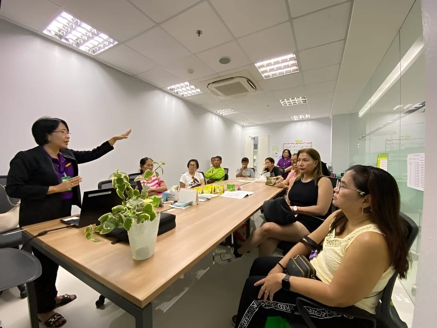 NOVADECI team in a meeting room discussing member loan programs