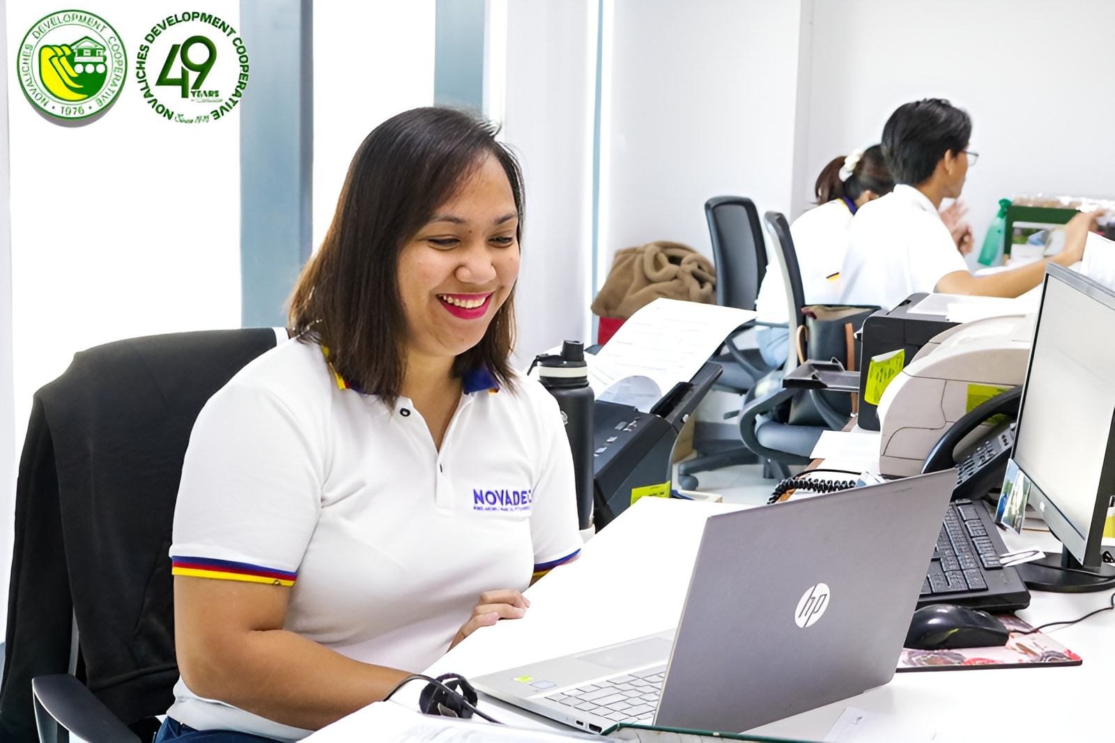 NOVADECI staff member assisting with membership through a laptop